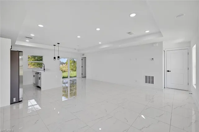 a view of kitchen with furniture and refrigerator