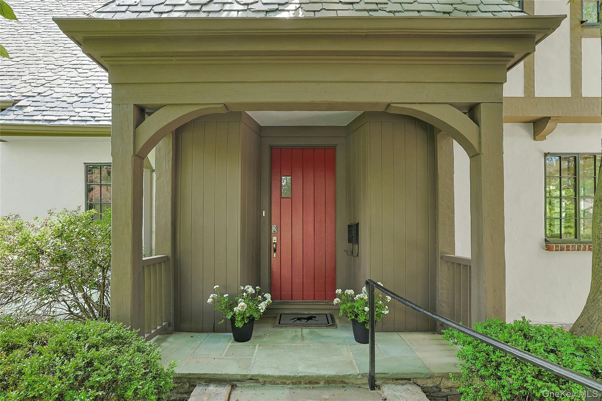 14 Withington Road Scarsdale, NY 10583 - Photo 3 of 41 a front view of a house with potted plants