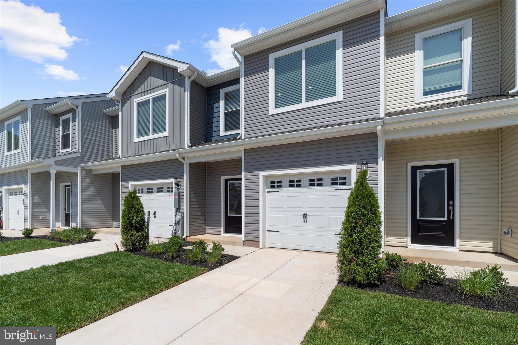 8133 Bartholomew Court Baltimore, MD 21206 - Photo 2 of 14 a front view of a house with a garden and plants