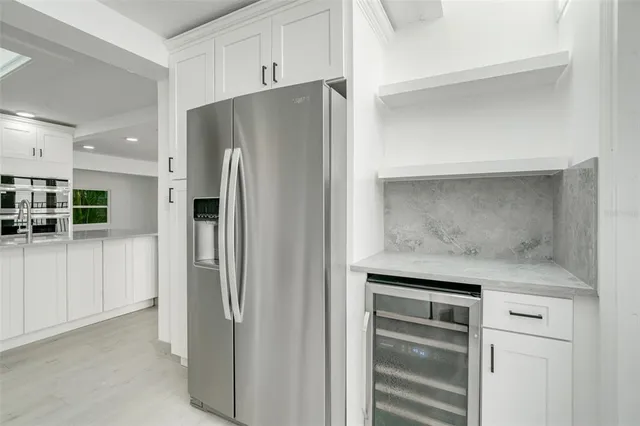 a metallic refrigerator freezer sitting in a kitchen