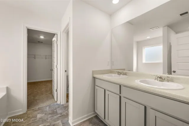 a bathroom with a sink double vanity and a mirror