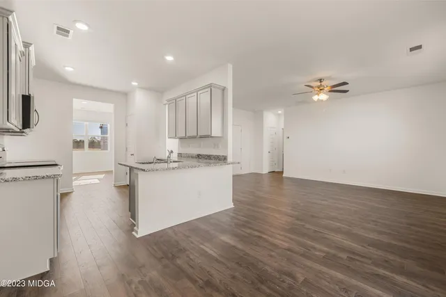 an empty room with wooden floor and closet