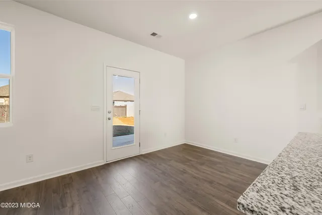 wooden floor with white cabinets and wooden floor