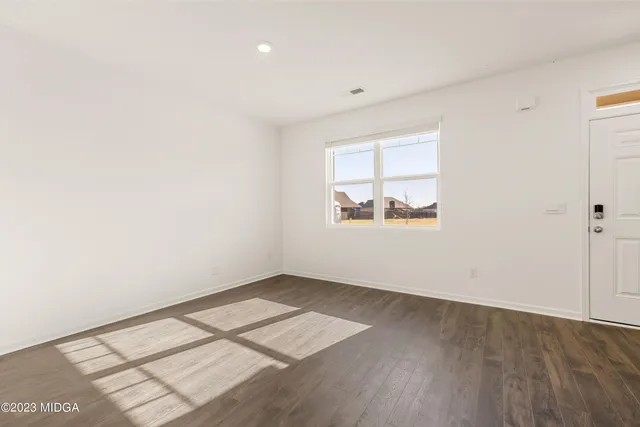 a view of an empty room and a window