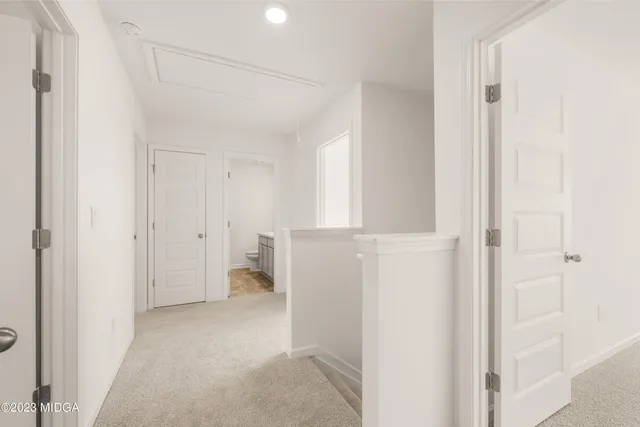 a view of an empty room with a ceiling fan