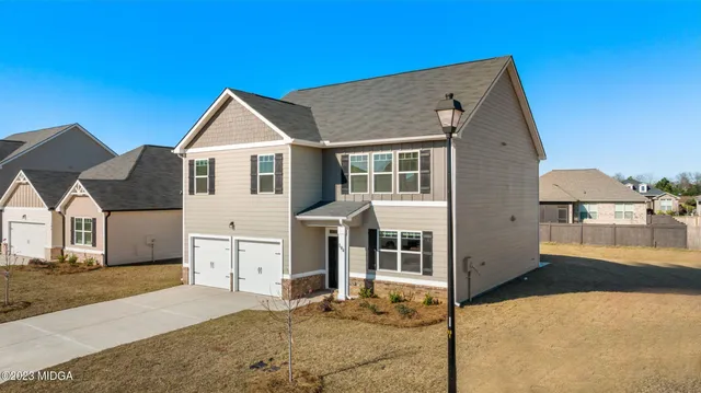 a patio with a table and chairs under an umbrella