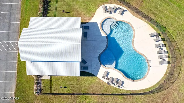 a view of a swimming pool with an outdoor seating