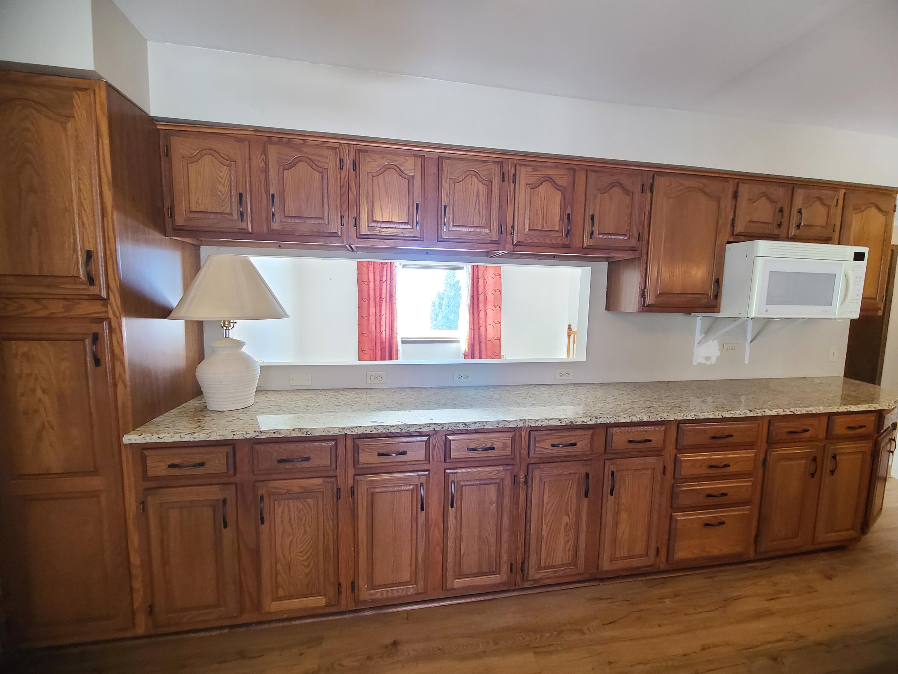 13291 County Road 700 West Demotte, IN 46310 - Photo 11 of 33 a kitchen with granite countertop a wooden cabinets and a sink