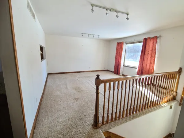 a view of a hallway with windows