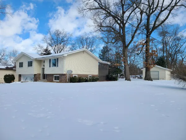 a view of a house with a yard covered with snow in front of house