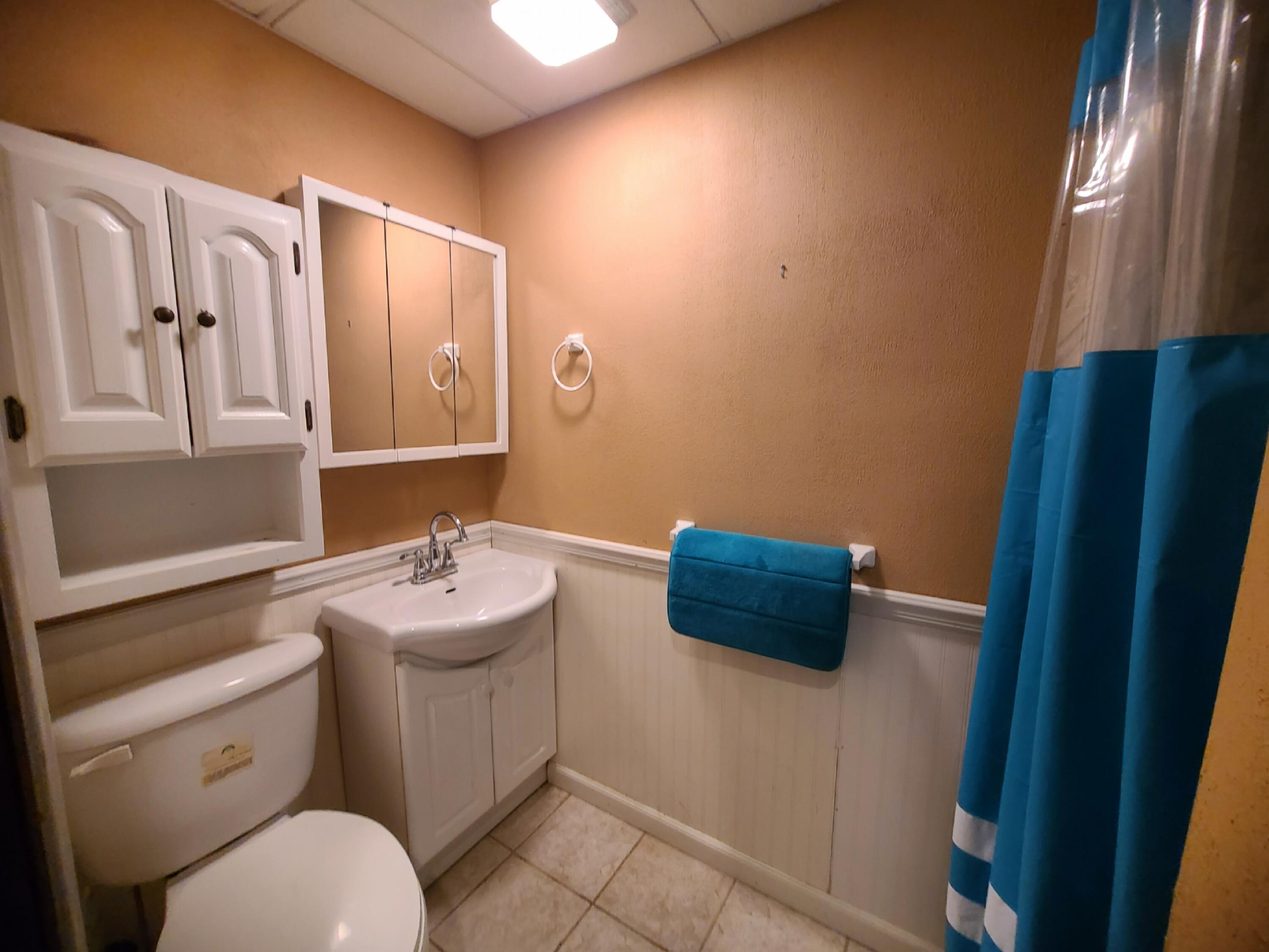 13291 County Road 700 West Demotte, IN 46310 - Photo 32 of 33 a bathroom with a toilet sink and mirror