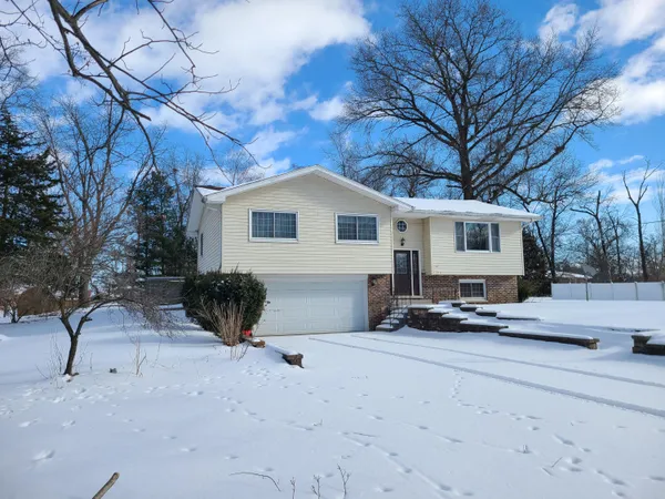 a view of a house with a snow in the yard