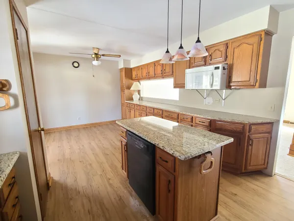 a kitchen with sink cabinets and wooden floor