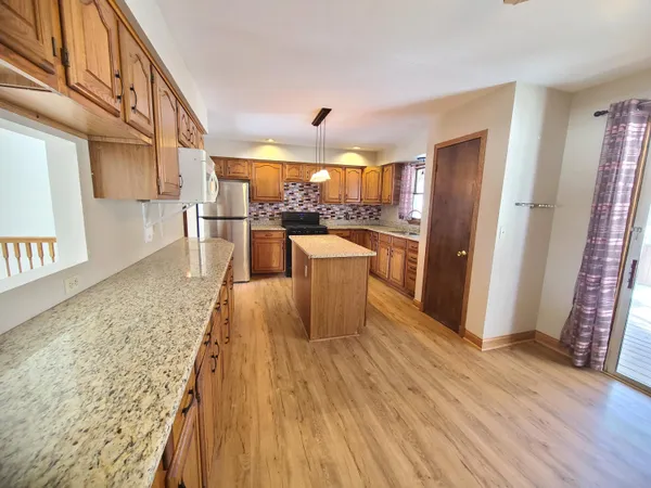 a view of a kitchen with wooden floor