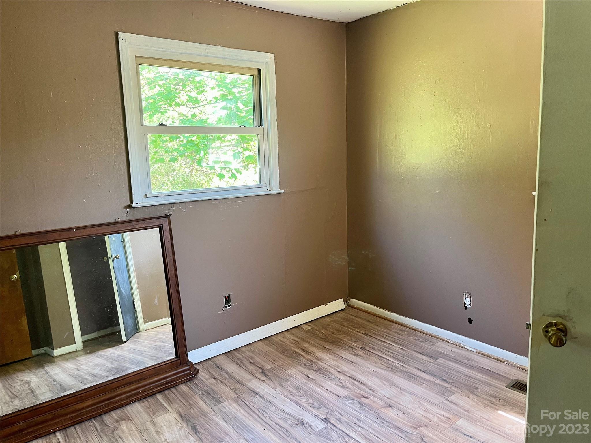 1411 Lackey Mountain Road Hiddenite, NC 28636 - Photo 12 of 19 a view of a room with wooden floor and small window
