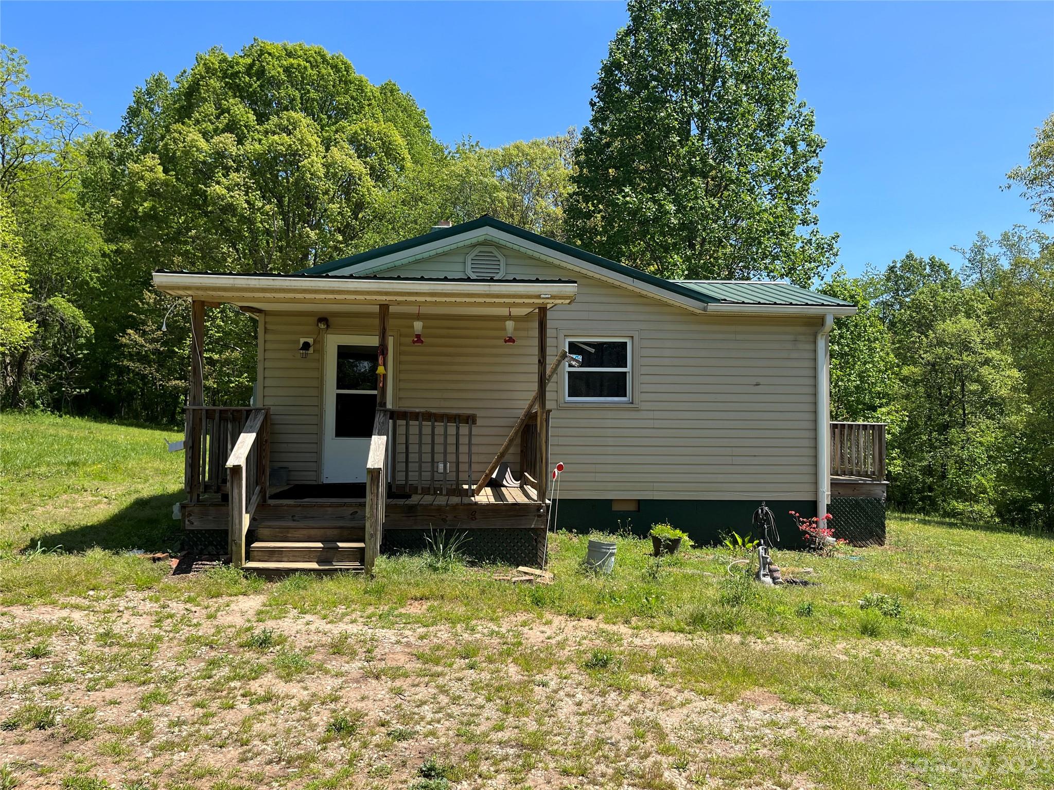 1411 Lackey Mountain Road Hiddenite, NC 28636 - Photo 3 of 19 a view of a house with a yard