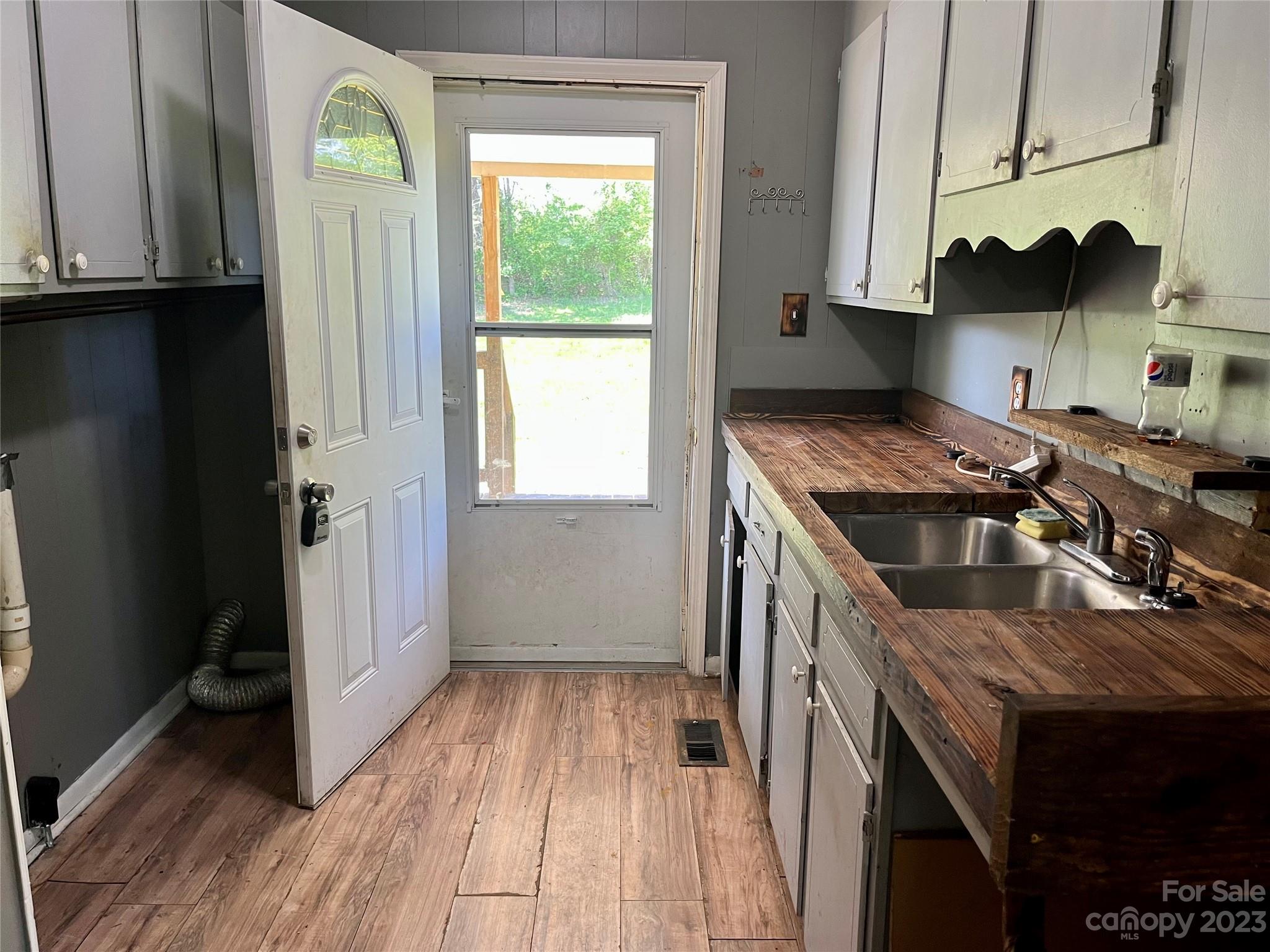 1411 Lackey Mountain Road Hiddenite, NC 28636 - Photo 6 of 19 a kitchen with stainless steel appliances granite countertop a stove a sink and a refrigerator