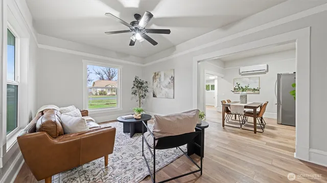 a living room with furniture and a wooden floor