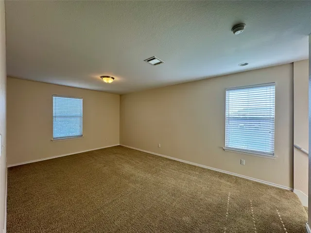 an empty room with a empty space and windows