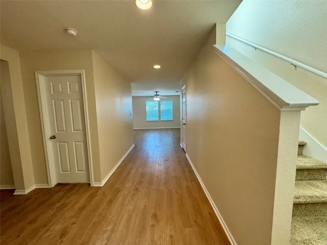 a view of hallway with wooden floor