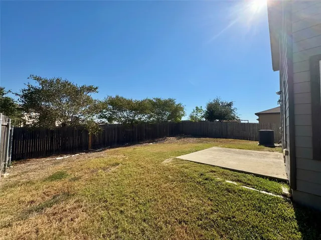 a swimming pool with an outdoor space and seating area