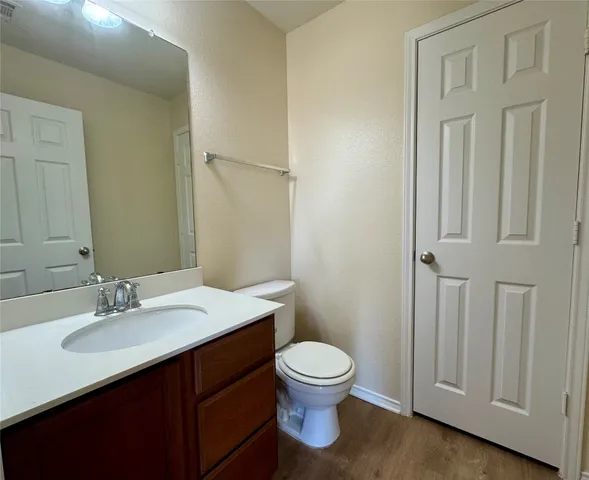 a bathroom with a sink a toilet and mirror