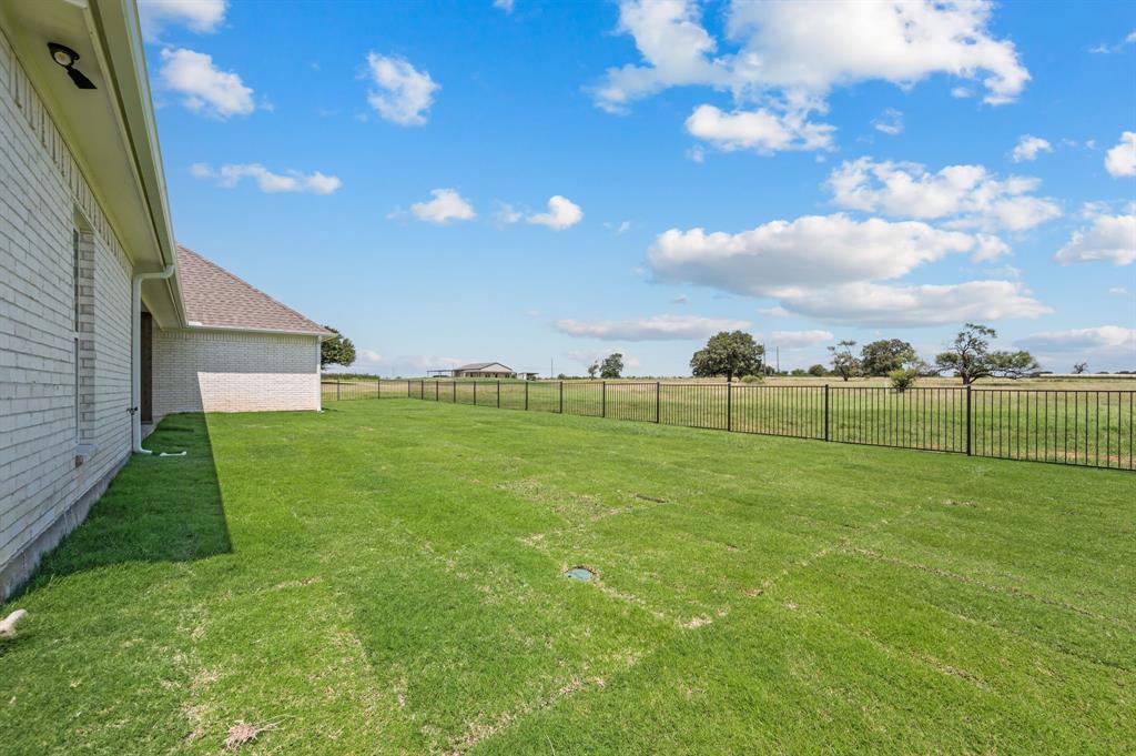 2705 Gospel Road Tolar, TX 76476 - Photo 28 of 36 Expansive green lawn bounded by a black metal fence