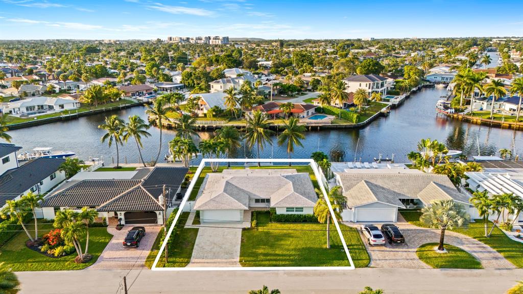 an aerial view of residential houses with outdoor space and swimming pool