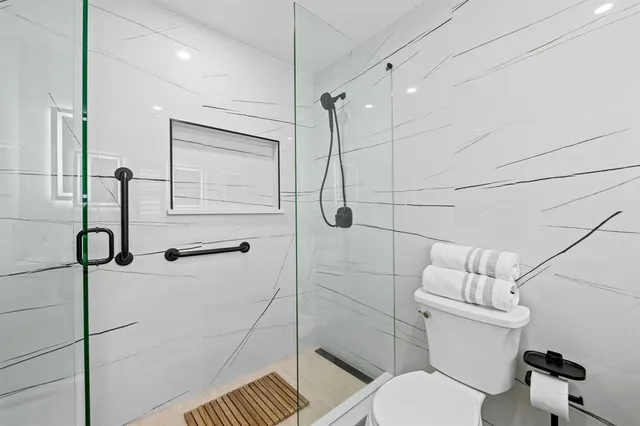 a bathroom with a toilet and a shower