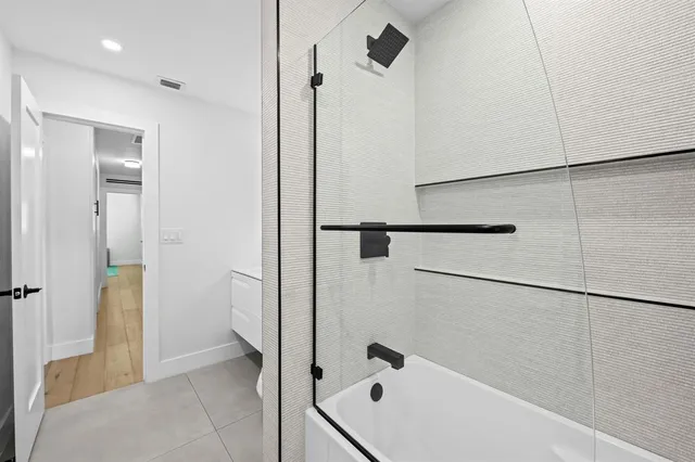 a bathroom with a bathtub and a shower