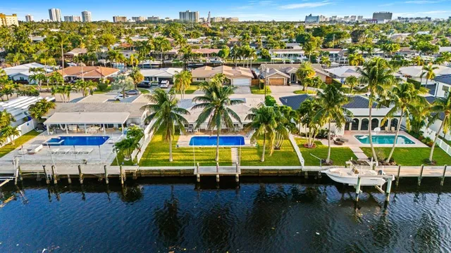 a view of a swimming pool with a lawn chairs under an umbrella