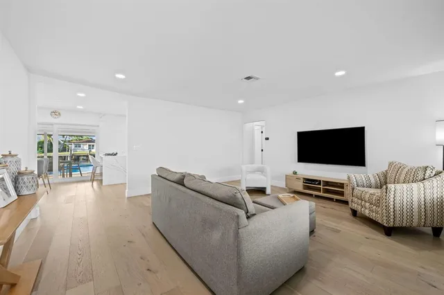 a front view of a house with a yard and potted plants