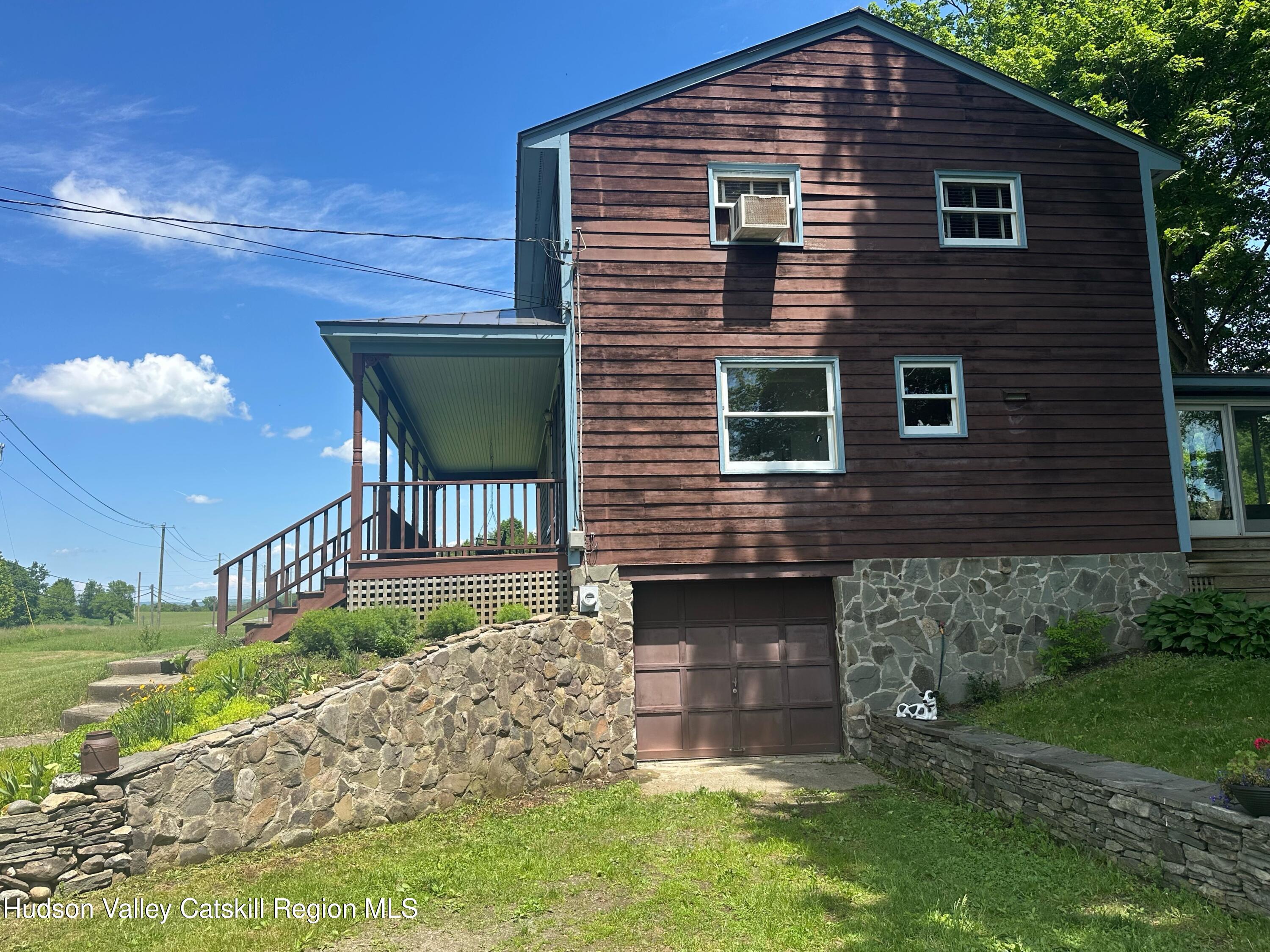 1492 County Road Copake, NY 12516 - Photo 17 of 34 a front view of a house with a garden