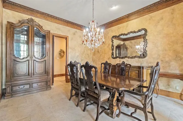 a view of a dining room with furniture and chandelier