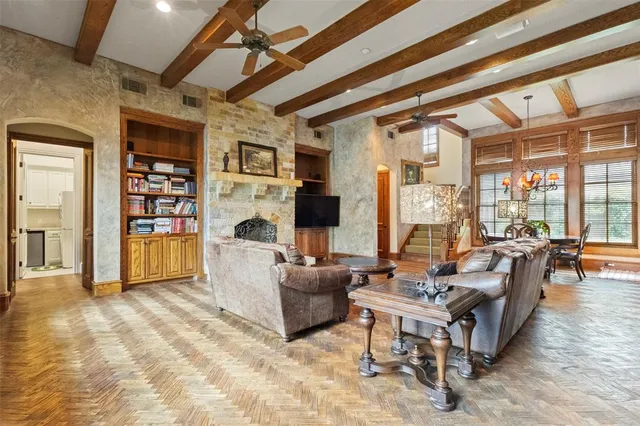 a living room with fireplace furniture and a floor to ceiling window