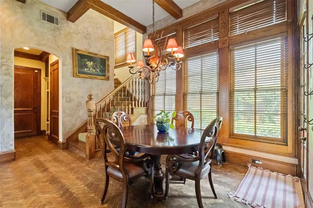 a view of a dining room with furniture and a window