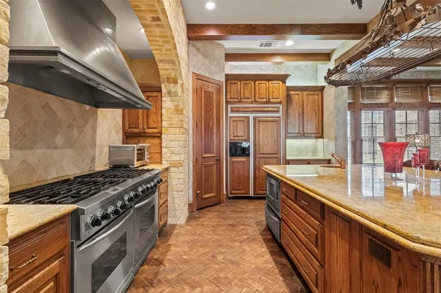 a kitchen with stainless steel appliances granite countertop a stove and a sink