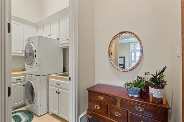 a room with painting on the wall a washer and dryer