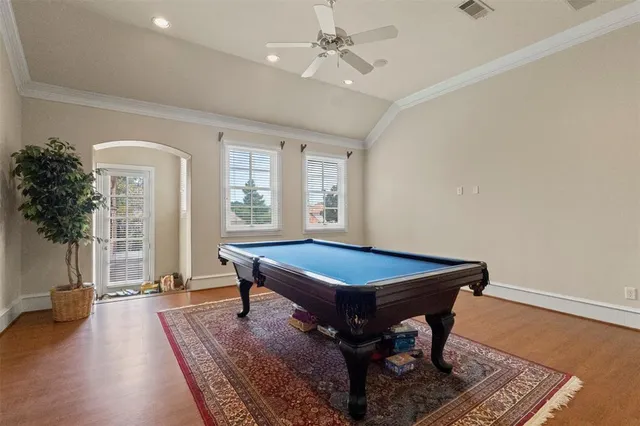 a room with pool table and windows