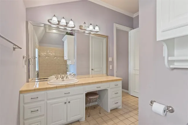 a bathroom with a sink a mirror and a light fixture