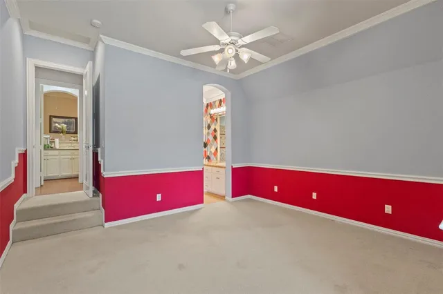 a view of an empty room with window and cabinet