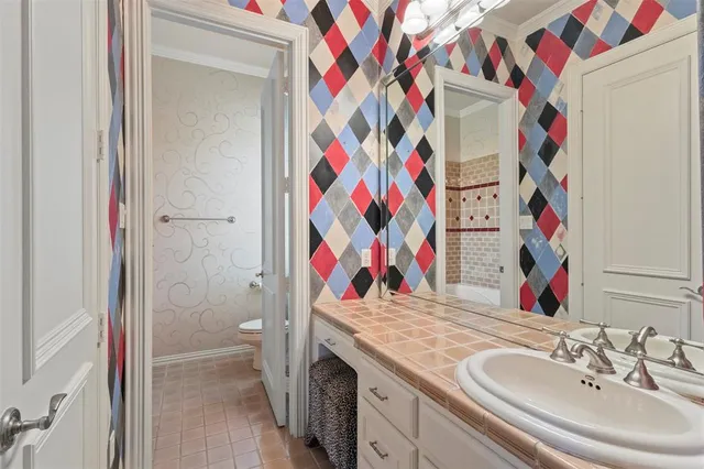 a bathroom with a sink mirror and vanity