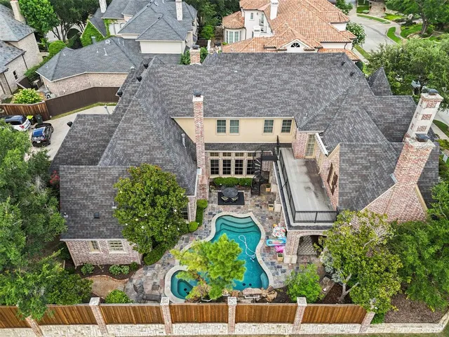 an aerial view of a house with a yard and potted plants