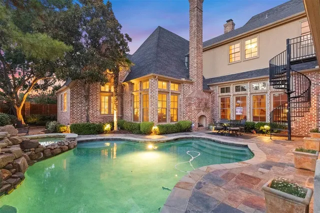 a swimming pool with outdoor seating and yard