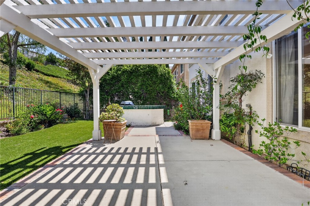 20543 Pesaro Porter Ranch Porter Ranch, CA 91326 - Photo 64 of 67 a view of a patio with table and chairs potted plants with wooden floor and fence