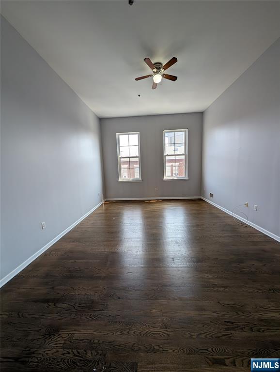 19 Market Street, Unit 405 Paterson, NJ 07501 - Photo 6 of 14 a view of an empty room with wooden floor and a window
