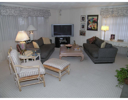 25 West Boulevard Road Newton, MA 02459 - Photo 5 of 8 a living room with furniture a lamp and a flat screen tv