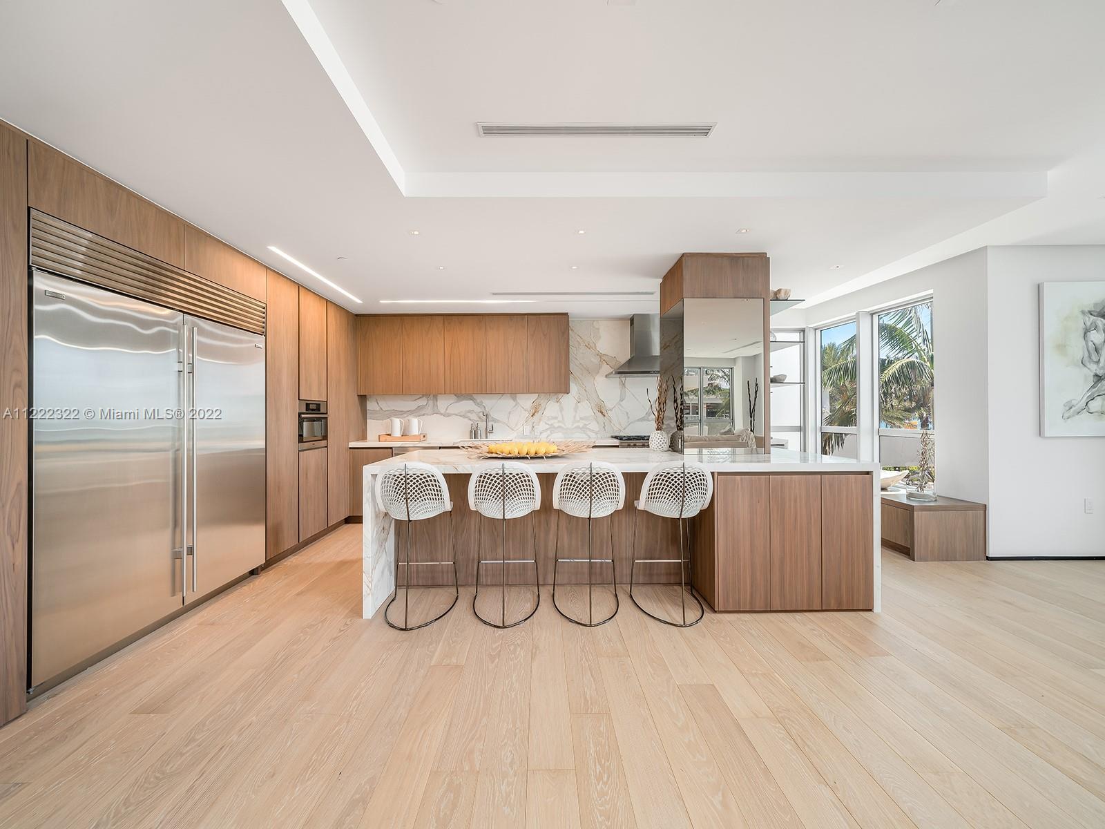 125 Ocean Drive, Unit U0301 Miami Beach, FL 33139 - Photo 3 of 15 a dining hall with stainless steel appliances granite countertop a refrigerator a sink dishwasher a dining table and chairs with wooden floor