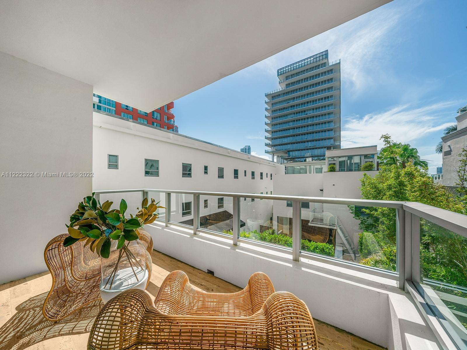 125 Ocean Drive, Unit U0301 Miami Beach, FL 33139 - Photo 6 of 15 a balcony with furniture and flowers