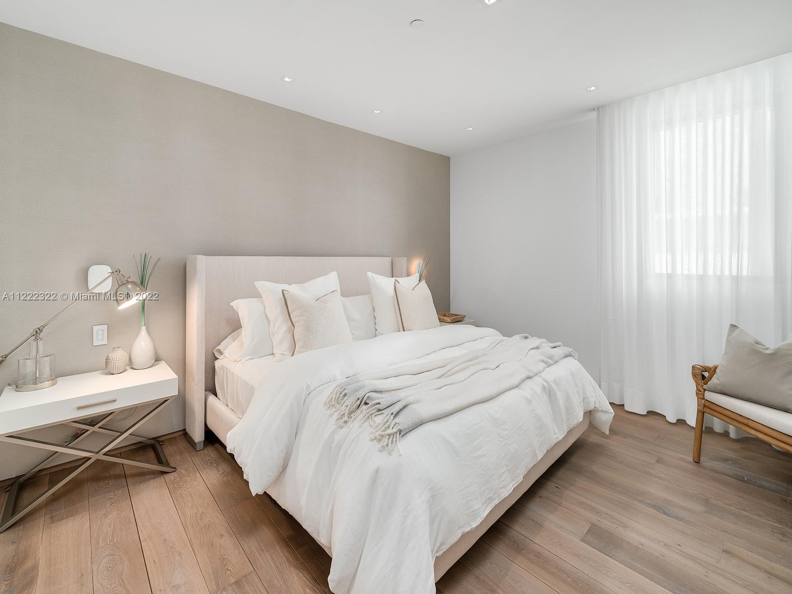 125 Ocean Drive, Unit U0301 Miami Beach, FL 33139 - Photo 7 of 15 a bedroom with a bed and a chair